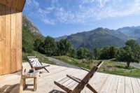 Wooden chairs on deck with scenic mountain views 