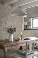 Country dining room with exposed stone wall