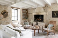 Country living room with stone walls and fireplace