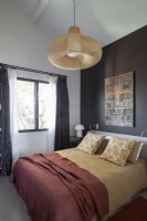 Modern bedroom with black feature wall 
