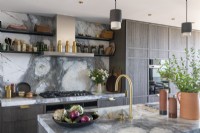 Elegant contemporary kitchen with marble worktop and splashback