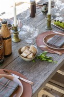 Detail of wooden outdoor dining table set for lunch