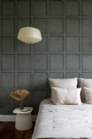 Classic panelled wall in modern black and white bedroom