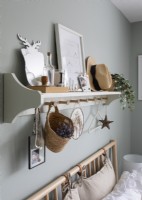 Shelf and coat hooks for accessories above bed - detail