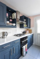 Modern kitchen with dark grey units and pink painted walls