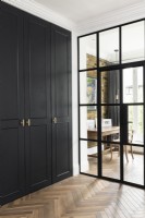 Floor to ceiling wardrobes, crittall style doors looking into home office.