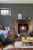 Sally and John Biddle's house in Cornwall, grey and white living room with wood burning stove and mid century furniture