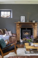 Grey painted living room with wood burning stove and mid century furniture