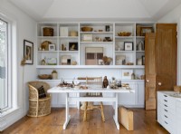 Large white shelving unit and desk in white and wooden workshop