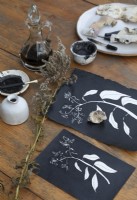 Detail of black and white painted fabric on wooden dining table