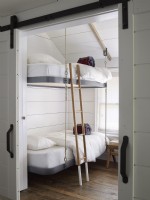 Kids room with hanging bunk beds and barn doors