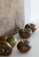 Detail of large tomatoes on kitchen worktop