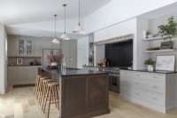 Barstools next to large island in modern kitchen