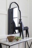 Black wooden horse sculpture on hallway table