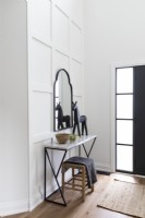 Small modern console table in monochrome hallway