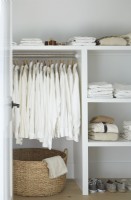Closet with open shelving and white clothes