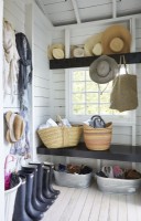 Rustic mudroom with basket, hats and boots