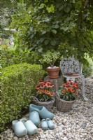 Garden detail with stones and blue clogs