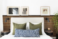 Upholstered bed with a slatted wall.