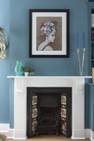 Classic victorian fireplace in bold blue living room