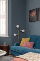 colourful sofa and cushions with retro floor lamp