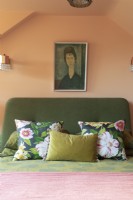 Bed and cushions detail in colourful loft bedroom