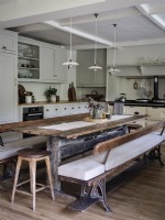 Neutral kitchen with reclaimed dining table and bench seating