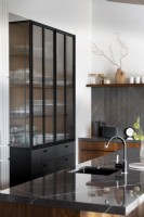 Fluted glass cabinet in kitchen with walnut detailing