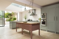 Classic contemporary large kitchen with free standing pink island.