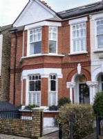 External view of a Victorian terrace, with brick arch porch 