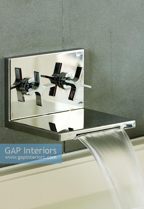Modern contemporary wall mounted chrome tap with running water