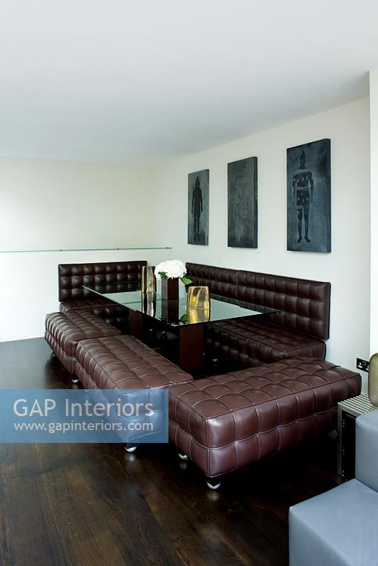 Modern dining room with brown leather benches