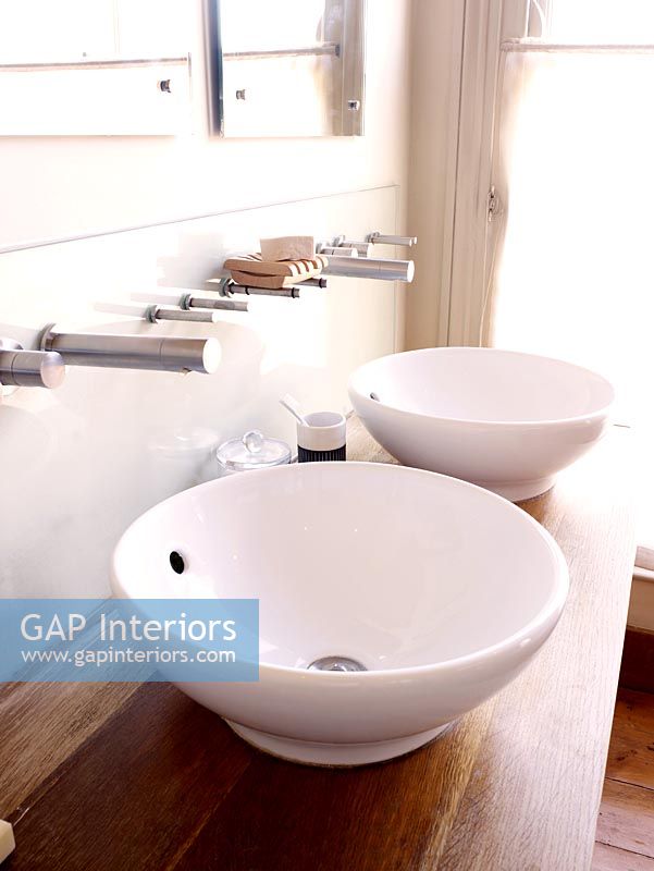Twin basins with wall mounted taps in modern bathroom 