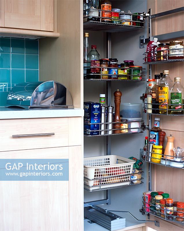 Modern kitchen open cupboard showing food storage solutions