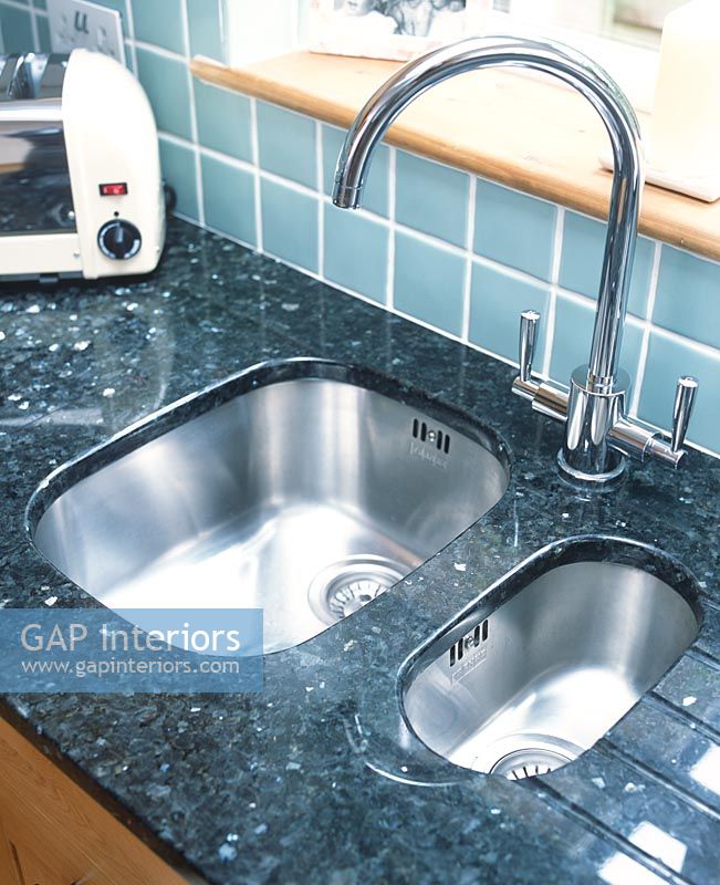 Detail of kitchen sink and granite worktop