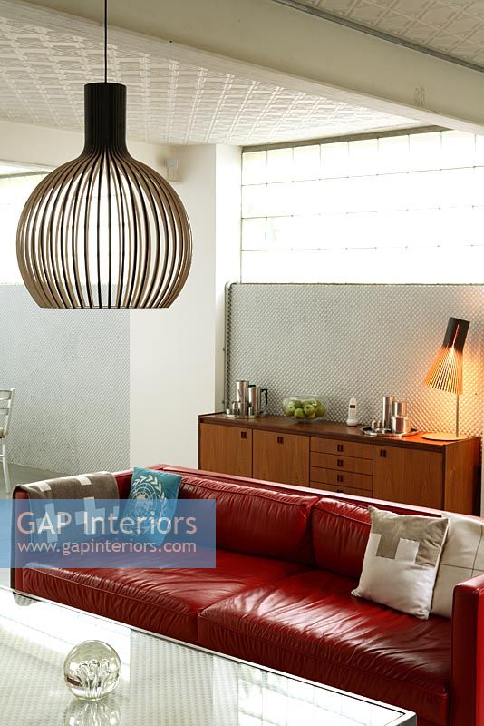 View to modern contemporary living room with Seppo Koho pendant light and lamp
