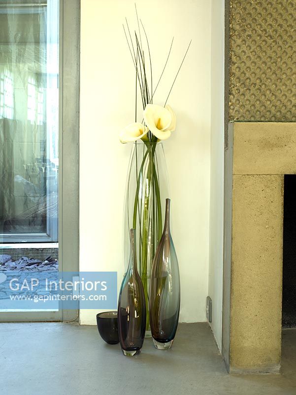 Detail of 3 large vases on concrete floor 