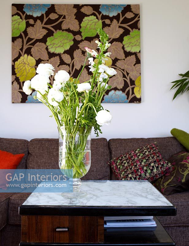 Detail of flowers in vase on coffee table in living room