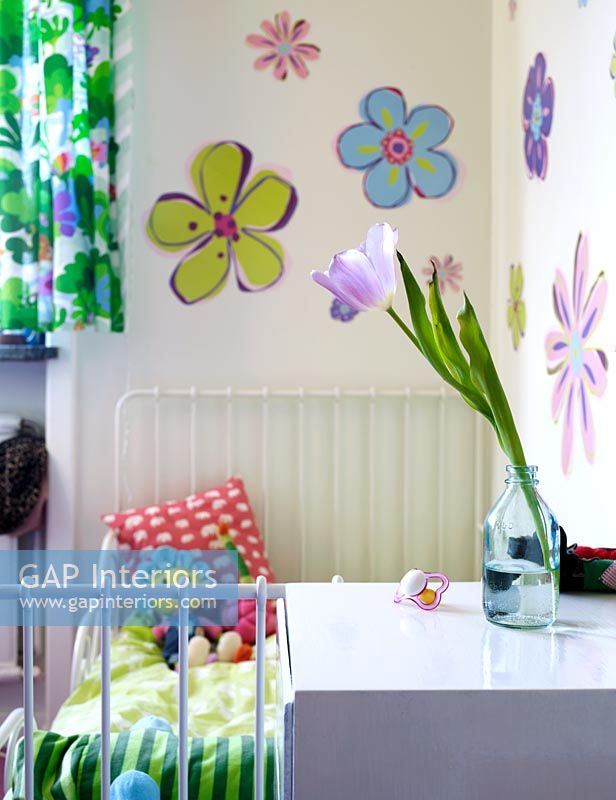 Childrens bedroom with flowers painted on wall