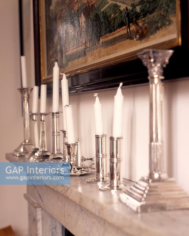 Detail of mantelpiece with silver candlesticks