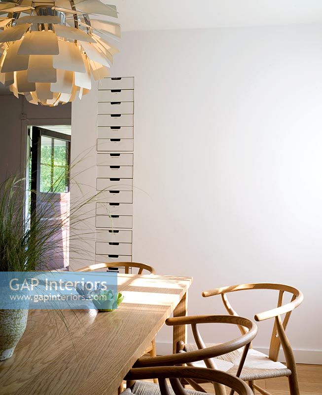 Modern dining room with Hans Wegner Y chairs and Poul Henningsen Artichoke pendant