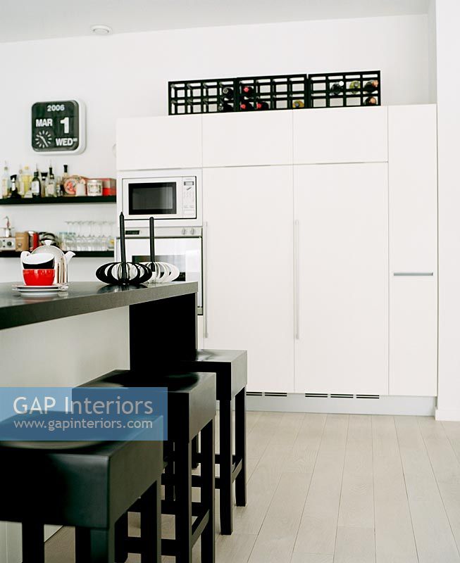 Modern white kitchen with black accessories