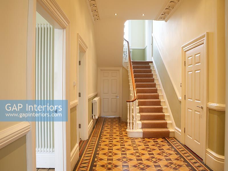 Hallway with patterned tiled floor