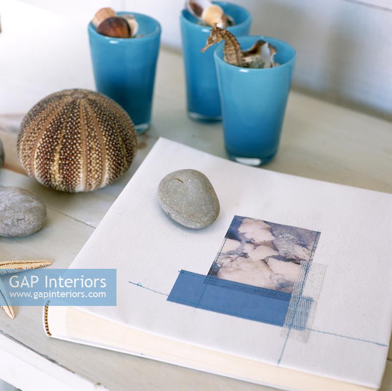 Variety of stones and shells beside book