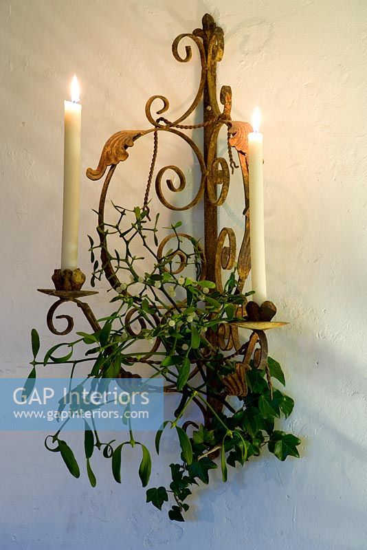 Ornate wall mounted candle holder with mistletoe