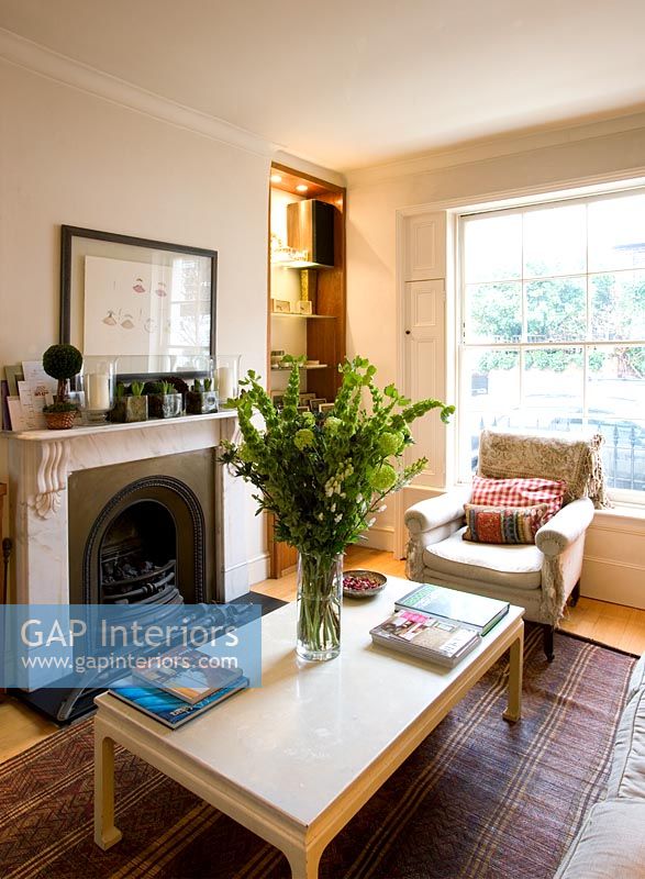Living room with vase of flowers on coffee table