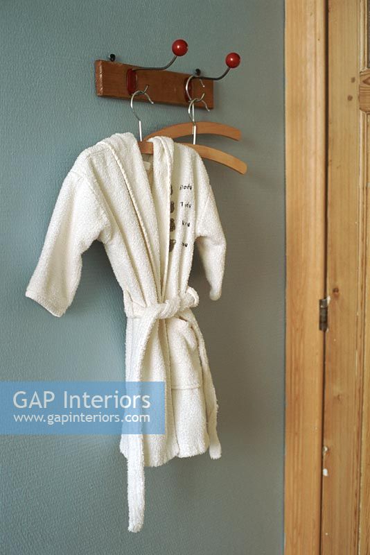View of bathrobe hanging from hook on wall