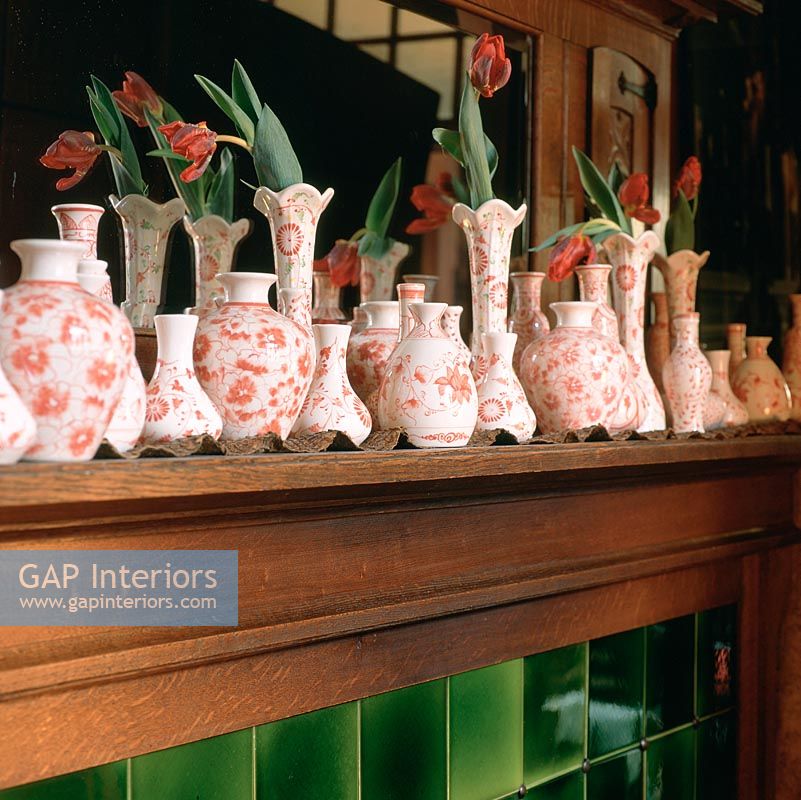 Row of flower vases in bedroom