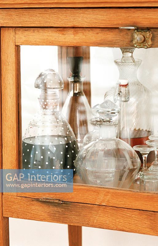 Close-up of display cabinet with a collection of decanters 