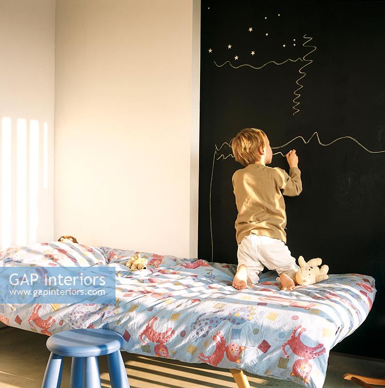 Child drawing on a blackboard